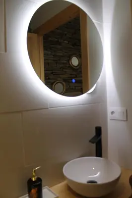 a bathroom with a white sink and a mirror at Hotel Apartamentos Casas da Fortaleza in Lugo