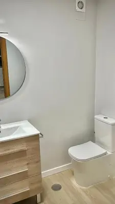 a bathroom with a white toilet and a sink at A Paradiña de Sarria in Sarria