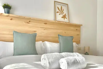 a white bed with two folded towels on it at A Paradiña de Sarria in Sarria