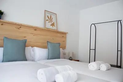 a bedroom with a bed with towels on it at A Paradiña de Sarria in Sarria