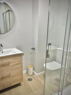 a bathroom with a sink and a toilet and a mirror at A Paradiña de Sarria in Sarria