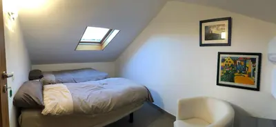 a small bedroom with a bed and a chair at Residencia DO PICHO in Palas de Rei