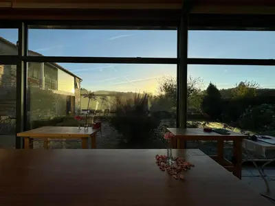 a room with a table and a large window at Residencia DO PICHO in Palas de Rei