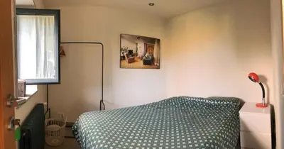 a bedroom with a bed and a picture on the wall at Residencia DO PICHO in Palas de Rei