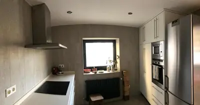 a kitchen with a refrigerator and a window at Residencia DO PICHO in Palas de Rei