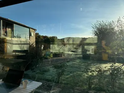 a view of a garden from a window of a house at Residencia DO PICHO in Palas de Rei