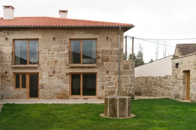 a stone house with a garden in front of it at Casa San Blas in Verín