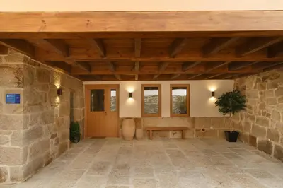 an entrance to a stone building with a wooden ceiling at Casa San Blas in Verín