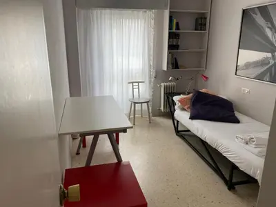 a small room with a bed and a table at Vistas do Eume in Puentedeume