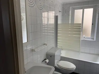 a white bathroom with a toilet and a sink at Vistas do Eume in Puentedeume