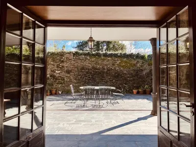 an open door to a patio with a table and chairs at Prioral Countryside Villa in Miño