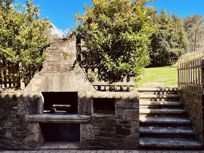 a stone structure with stairs and trees in a park at Prioral Countryside Villa in Miño