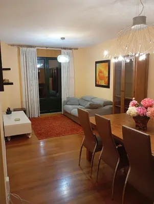 a living room with a table and a couch at Piso ABELEDO in Sarria
