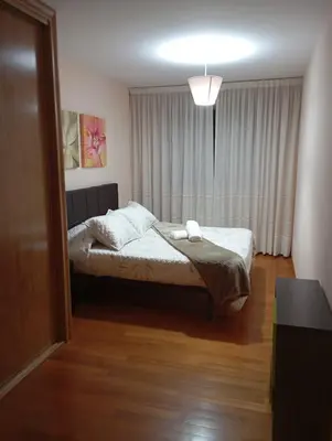 a bedroom with a bed and a large mirror at Piso ABELEDO in Sarria