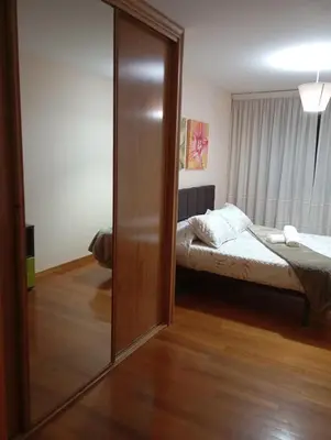 a bedroom with a bed and a sliding glass door at Piso ABELEDO in Sarria