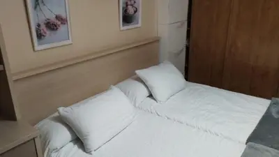 a white bed with two pillows in a room at Piso ABELEDO in Sarria