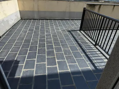 a tiled floor with a metal fence on it at Apartamento Miramar Ribadeo in Ribadeo