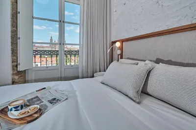 a bedroom with a bed with a newspaper on it at Hotel Gaio 7 in Santiago de Compostela