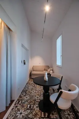 a living room with a table and chairs and a couch at Hotel Gaio 7 in Santiago de Compostela