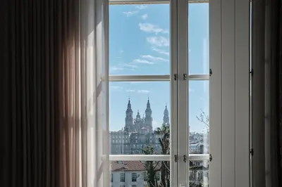 an open window with a view of a city at Hotel Gaio 7 in Santiago de Compostela