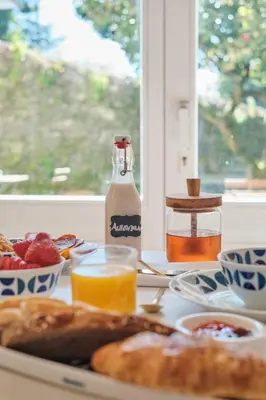 a table with a plate of breakfast food and a bottle of milk at Hotel Gaio 7 in Santiago de Compostela