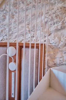 a room with a ceiling with a stone wall at Hotel Gaio 7 in Santiago de Compostela