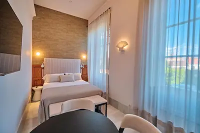 a hotel room with a bed and a window at Hotel Gaio 7 in Santiago de Compostela