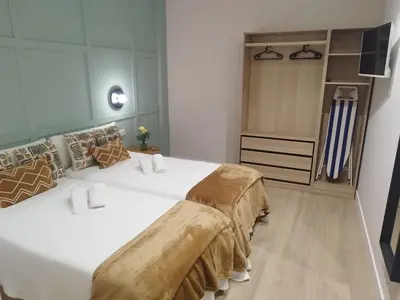 a bathroom with a toilet and a glass shower stall at Aqua Celenis in Caldas de Reis