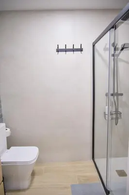 a bathroom with a white toilet and a sink at Aqua Celenis in Caldas de Reis