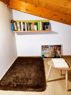 a room with a table and a book shelf at Hostal Restaurante LA SENDA in Camponaraya