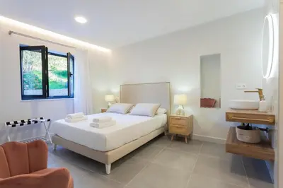 a white bedroom with a bed and a desk at Apartamentos PUERTO DE VIAVELEZ in Viavélez