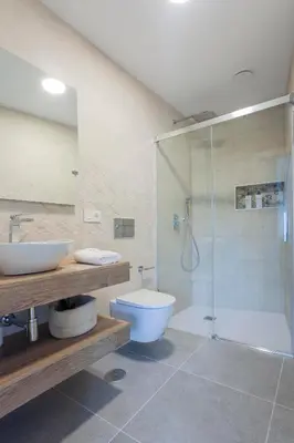 a bathroom with a shower and a toilet and a sink at Apartamentos PUERTO DE VIAVELEZ in Viavélez