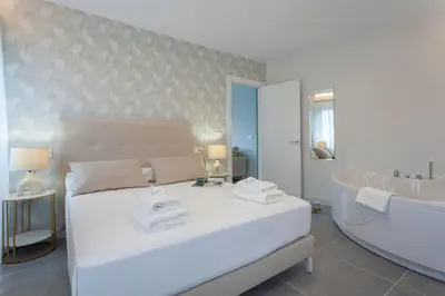 a bedroom with a large bed and a bath tub at Apartamentos PUERTO DE VIAVELEZ in Viavélez