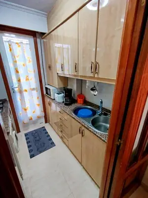 a small kitchen with a sink and a window at Vivienda Maceda in Maceda