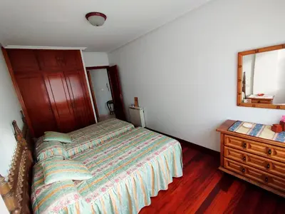 a bedroom with a bed and a dresser and a mirror at Vivienda Maceda in Maceda