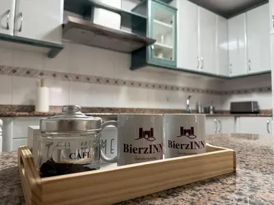 two mugs on a wooden tray on a kitchen counter at BierzINN Alojamientos - Martina II in Ponferrada