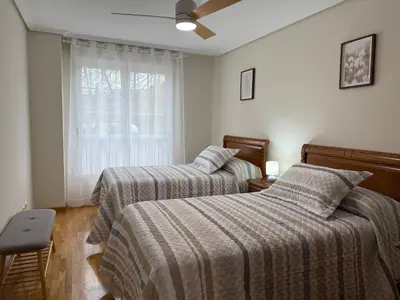 a bedroom with two beds and a window at BierzINN Alojamientos - Martina II in Ponferrada