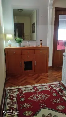 a bathroom with a dresser with a mirror at Piso céntrico en Padrón in Padrón