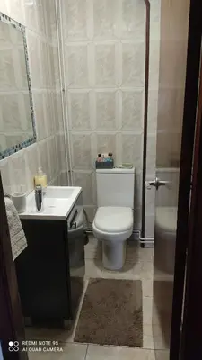 a bathroom with a toilet and a sink and a tub at Piso céntrico en Padrón in Padrón