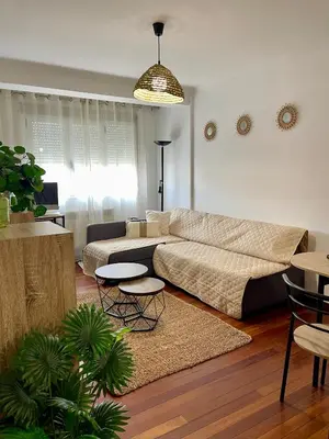 a living room with a couch and a table at Apartamento Cardenal Monforte in Monforte de Lemos