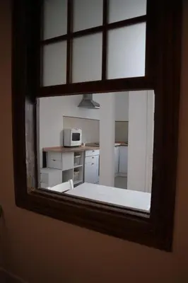 a view of a kitchen through a window at El refugio de las Burgas in Ourense