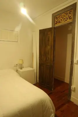 a bedroom with a bed and an open door at El refugio de las Burgas in Ourense
