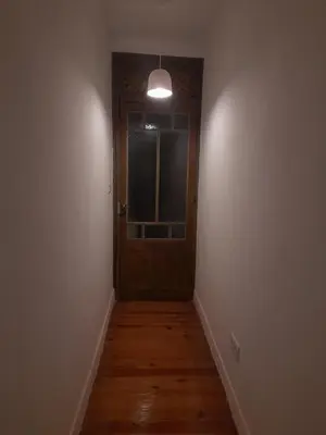 an empty hallway with a door and a window at El refugio de las Burgas in Ourense