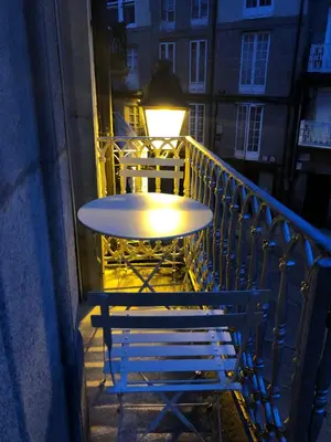 a table and a bench on a balcony at El refugio de las Burgas in Ourense