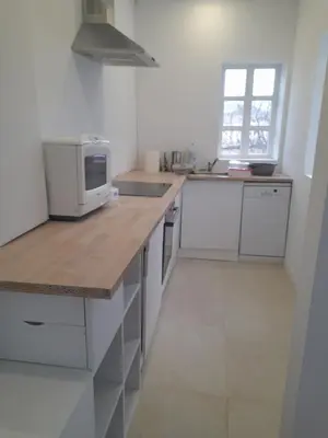 a kitchen with a counter top with a microwave at El refugio de las Burgas in Ourense