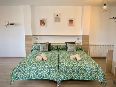 a large bed with two pillows on top of it at Cos pés en Palas in Palas de Rei