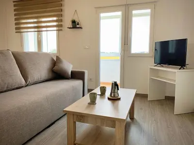 a living room with a couch and a coffee table at Cos pés en Palas in Palas de Rei