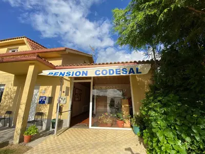 a building with a sign that reads pension coloredal at Pensión Codesal in O Pedrouzo