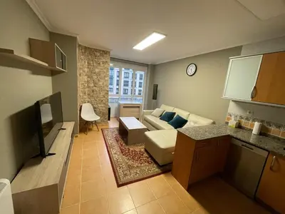 a living room with a couch and a table at Apartamento cerca del centro, y la playa in Viveiro