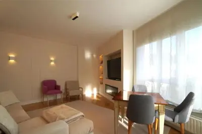 a living room with a couch and a table at Apartamento nuevo y cómodo in Guitiriz